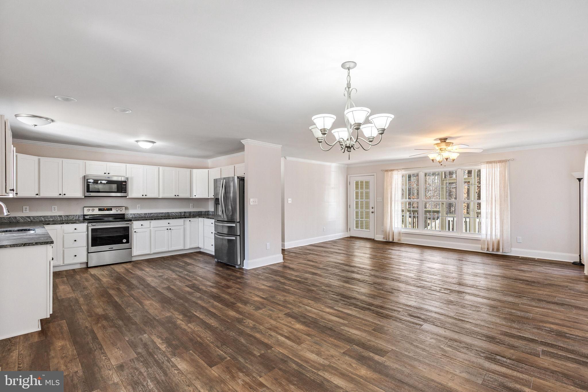 16352 Bullocks Road Ruther Glen, VA 22546 - Photo 9 of 29 a view of a kitchen with a sink cabinets and wooden floor