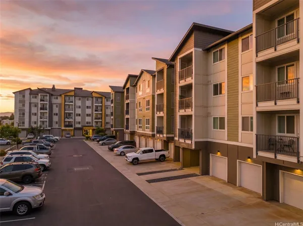 a city street lined with parked cars and buildings