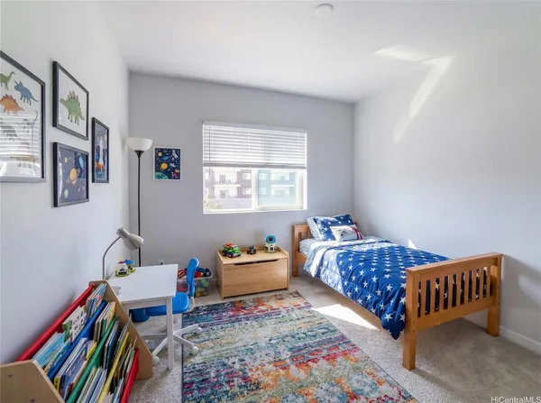 a bedroom with furniture and a rug