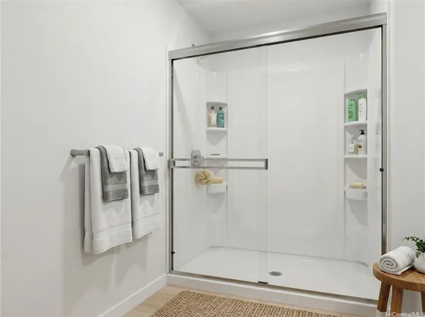 a bathroom with a glass shower door