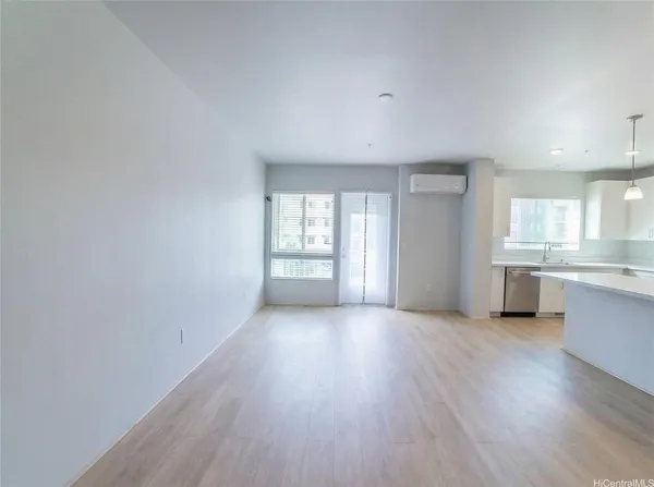 a view of a kitchen with wooden floor and a window
