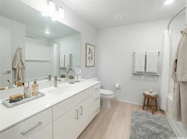 a bathroom with a sink a toilet and a mirror