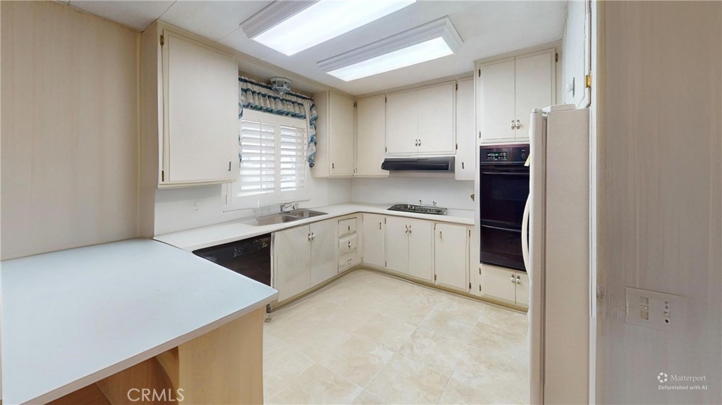 14851 Jeffrey Road, Unit 117 Irvine, CA 92618 - Photo 34 of 45 a kitchen with stainless steel appliances cabinets a sink and a window