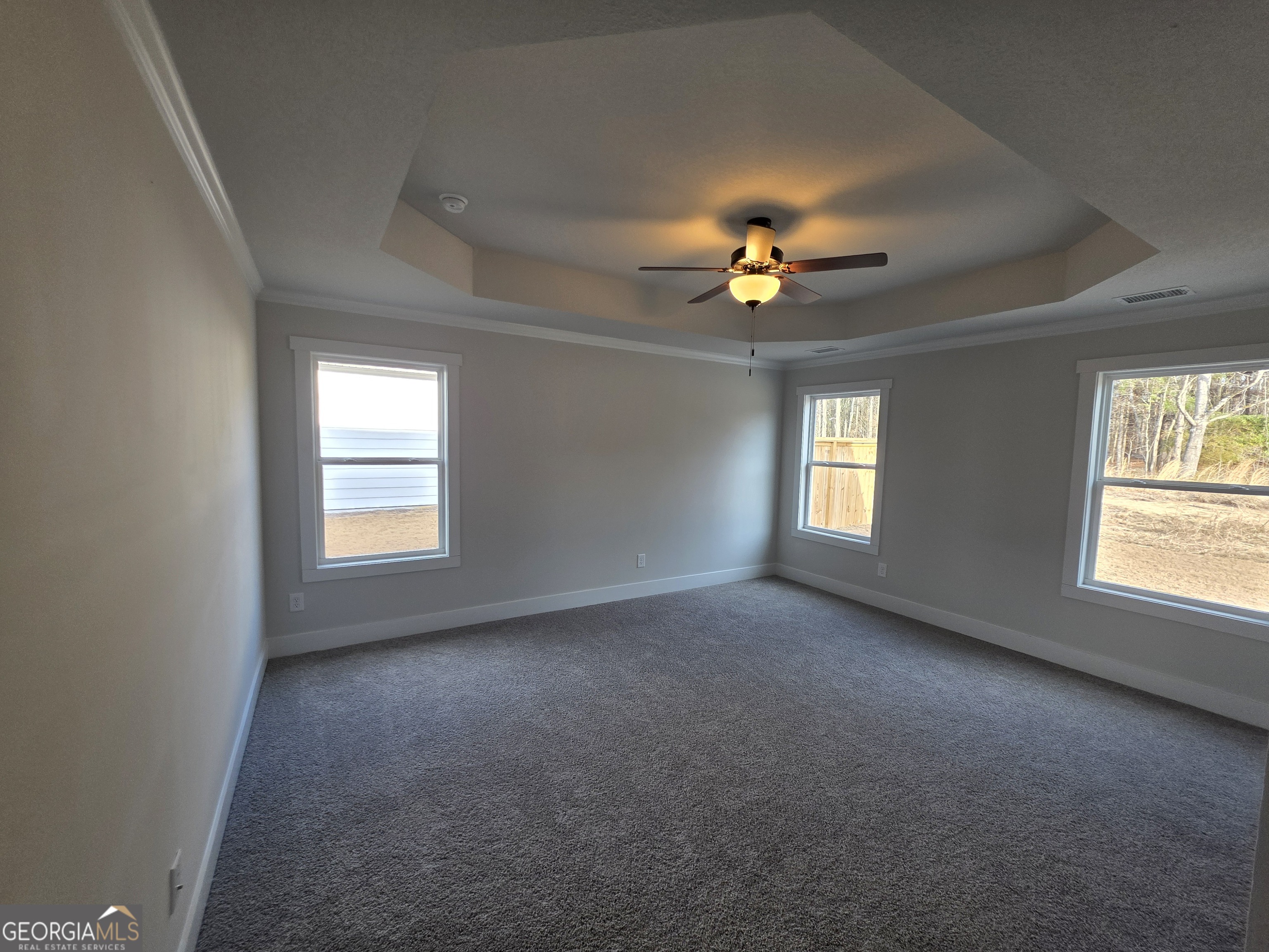 1167 Jeannine Lane, Unit 15 Winder, GA 30680 - Photo 12 of 14 an empty room with windows and chandelier fan