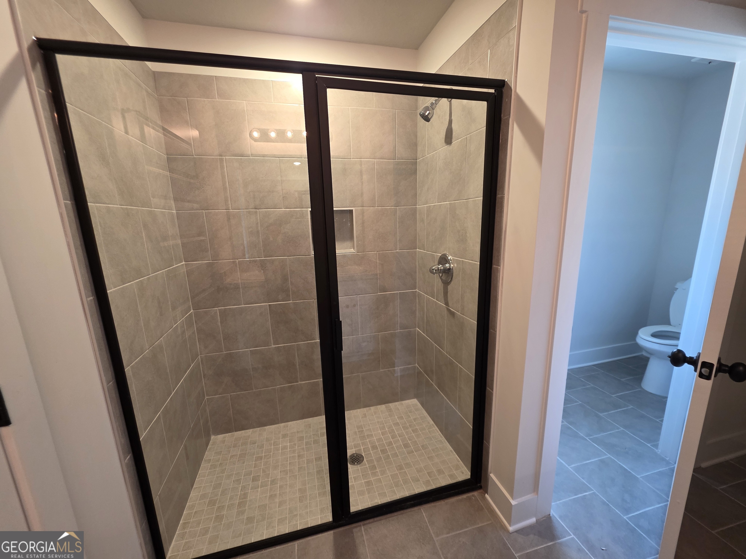 1167 Jeannine Lane, Unit 15 Winder, GA 30680 - Photo 14 of 14 a bathroom with a glass door shower