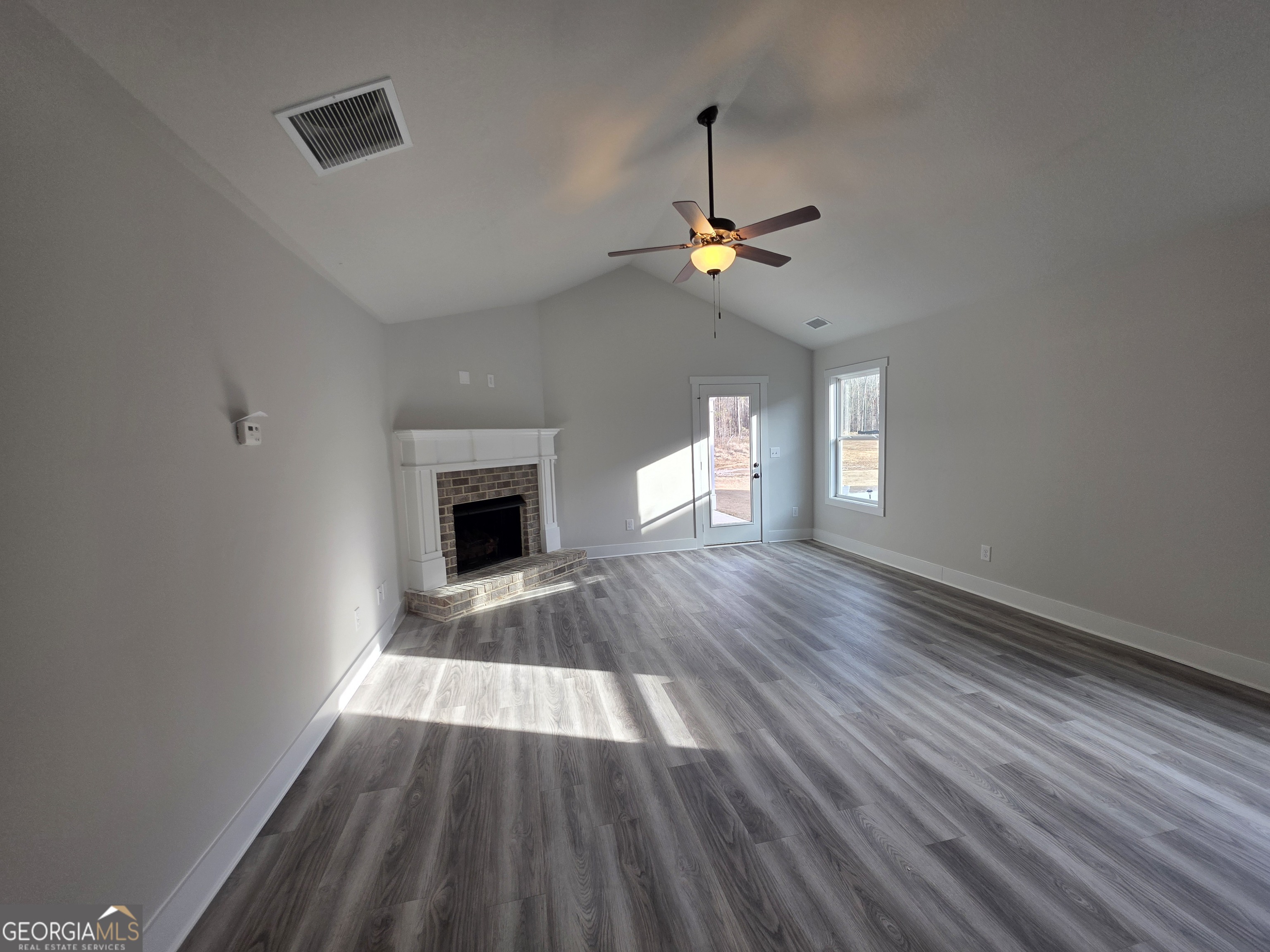 1167 Jeannine Lane, Unit 15 Winder, GA 30680 - Photo 5 of 14 wooden floor in an empty room with a window