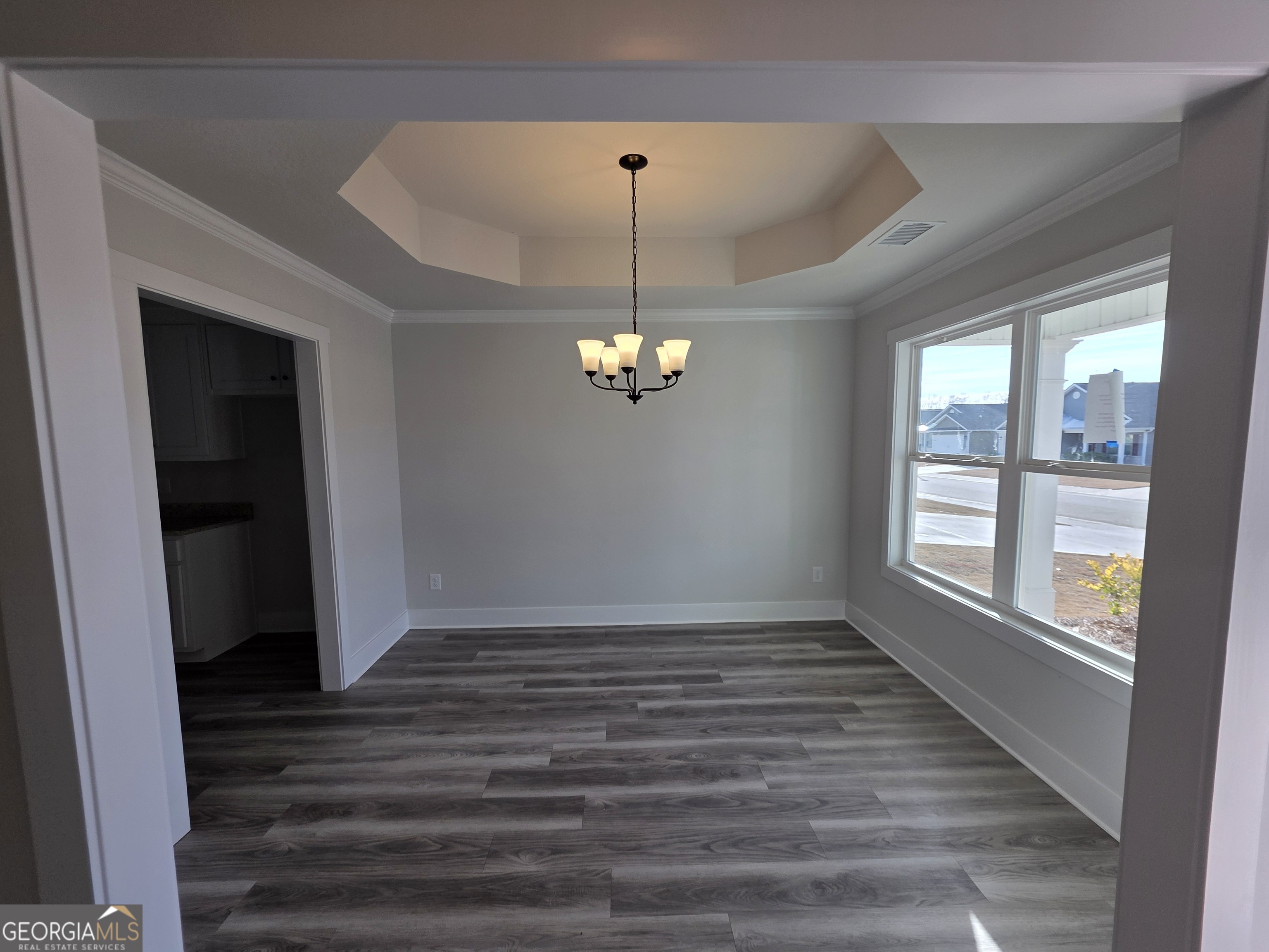 1167 Jeannine Lane, Unit 15 Winder, GA 30680 - Photo 6 of 14 wooden floor in an empty room with a window