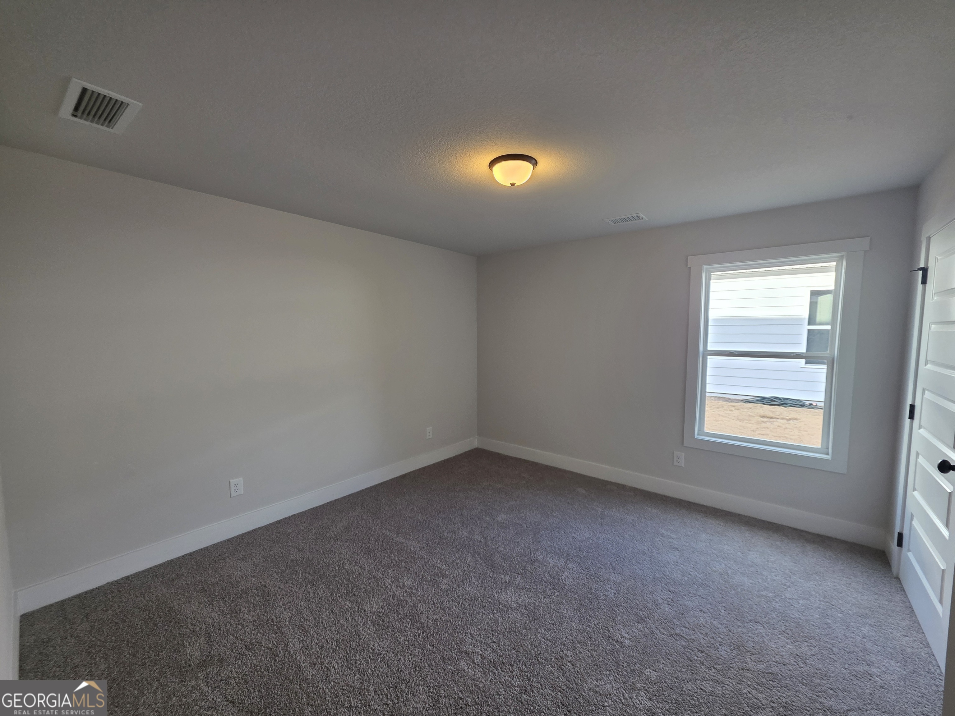1167 Jeannine Lane, Unit 15 Winder, GA 30680 - Photo 7 of 14 an empty room with a window
