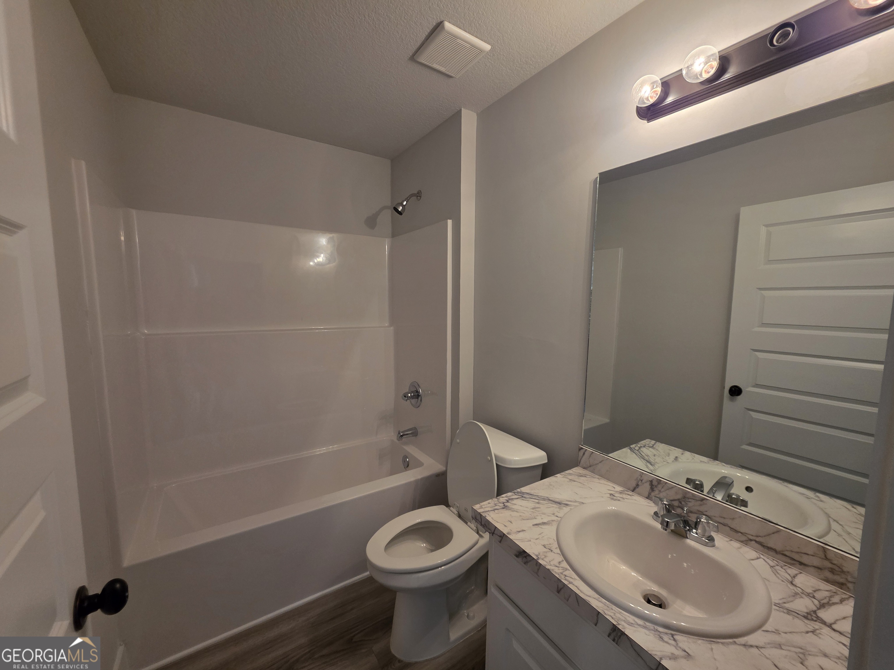 1167 Jeannine Lane, Unit 15 Winder, GA 30680 - Photo 9 of 14 a bathroom with a sink a toilet and shower