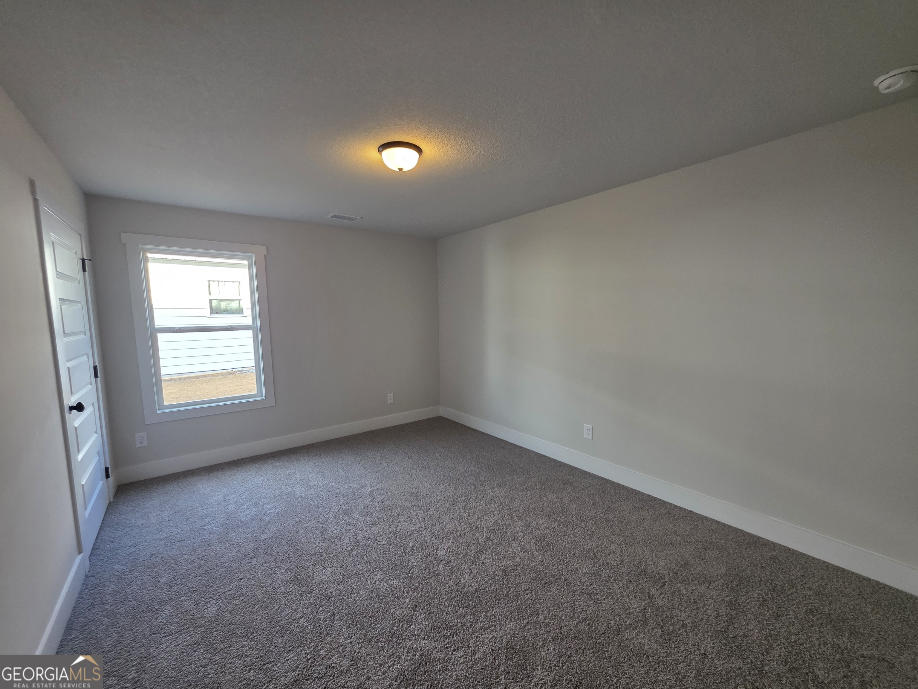 1167 Jeannine Lane, Unit 15 Winder, GA 30680 - Photo 10 of 14 an empty room with a window