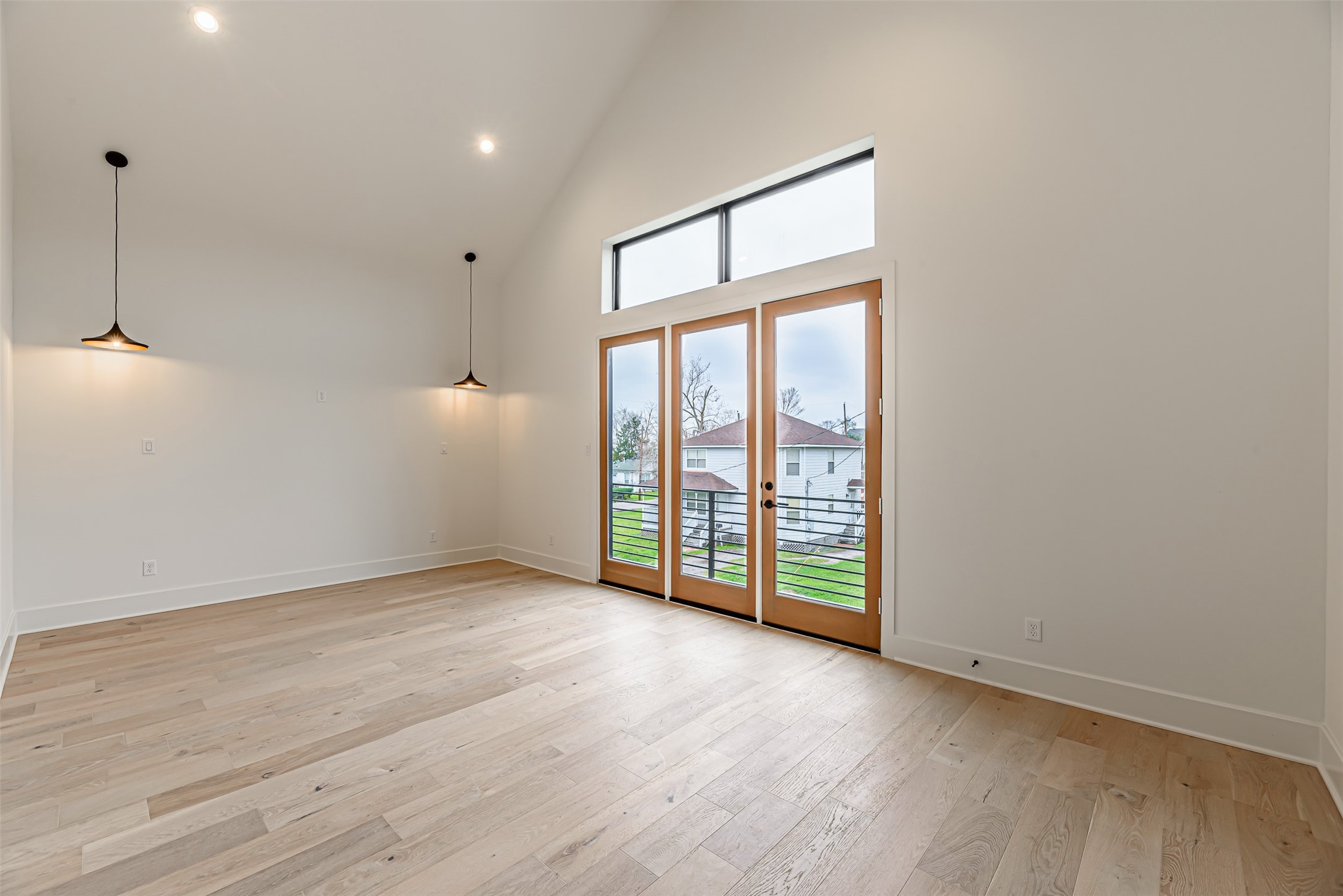 1104 West 9th Street Houston, TX 77007 - Photo 12 of 25 an empty room with wooden floor and windows