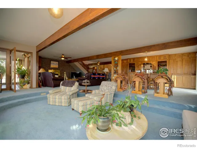 a living room with furniture and potted plants