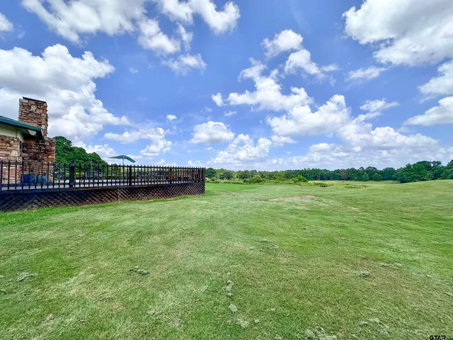 a view of a field with sky in the background