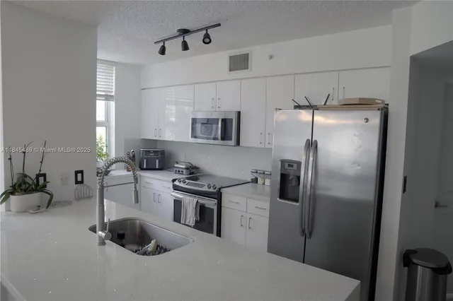 a bedroom with a bed window and potted plant