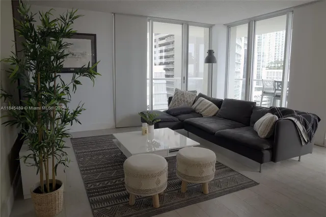 a living room with furniture and a potted plant