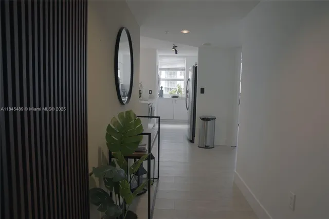 a kitchen with stainless steel appliances a refrigerator a sink a stove and a refrigerator