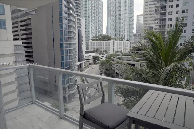 a view of a terrace with lawn chairs