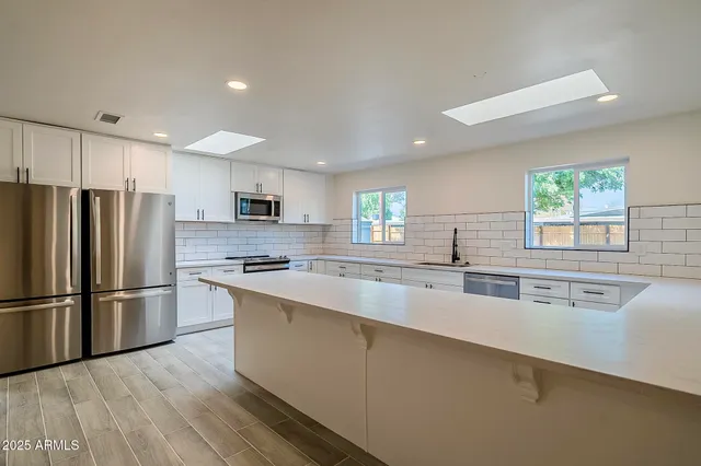 a kitchen with sink cabinets and wooden floor