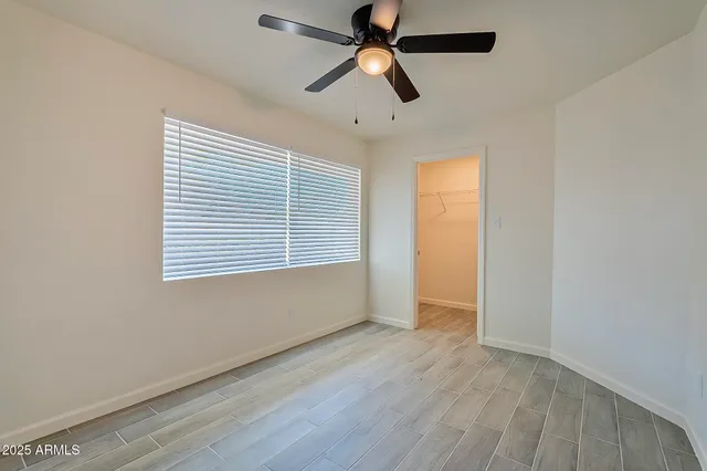 a kitchen with stainless steel appliances granite countertop a refrigerator a sink dishwasher a stove and a refrigerator with wooden floor