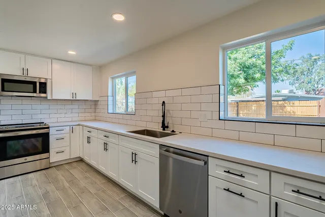 a view of kitchen with refrigerator microwave and wooden floor