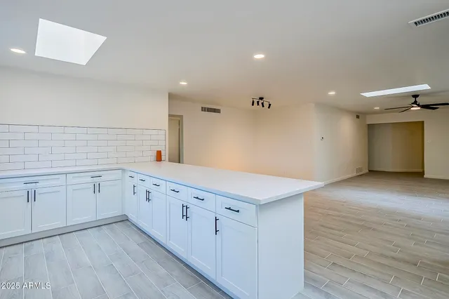 a kitchen with stainless steel appliances kitchen island wooden cabinets and granite counter tops