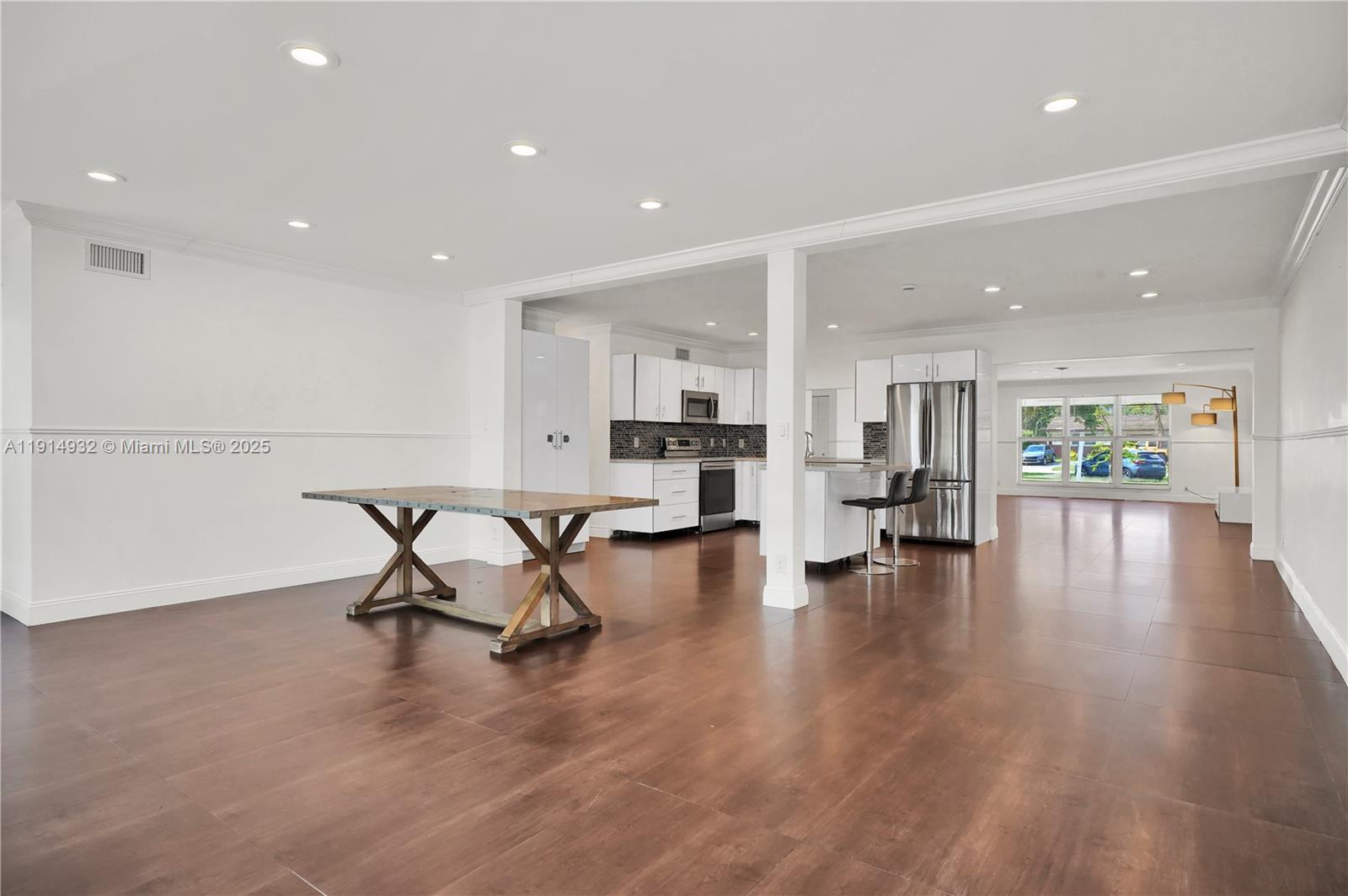 4721 West Park Road Hollywood, FL 33021 - Photo 12 of 34 a living room with furniture and kitchen view with wooden floor