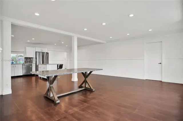 a view of a kitchen with dining table and chairs