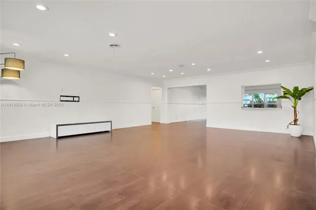 a view of an empty room with a potted plant