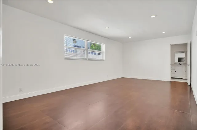 an empty room with a empty space and windows