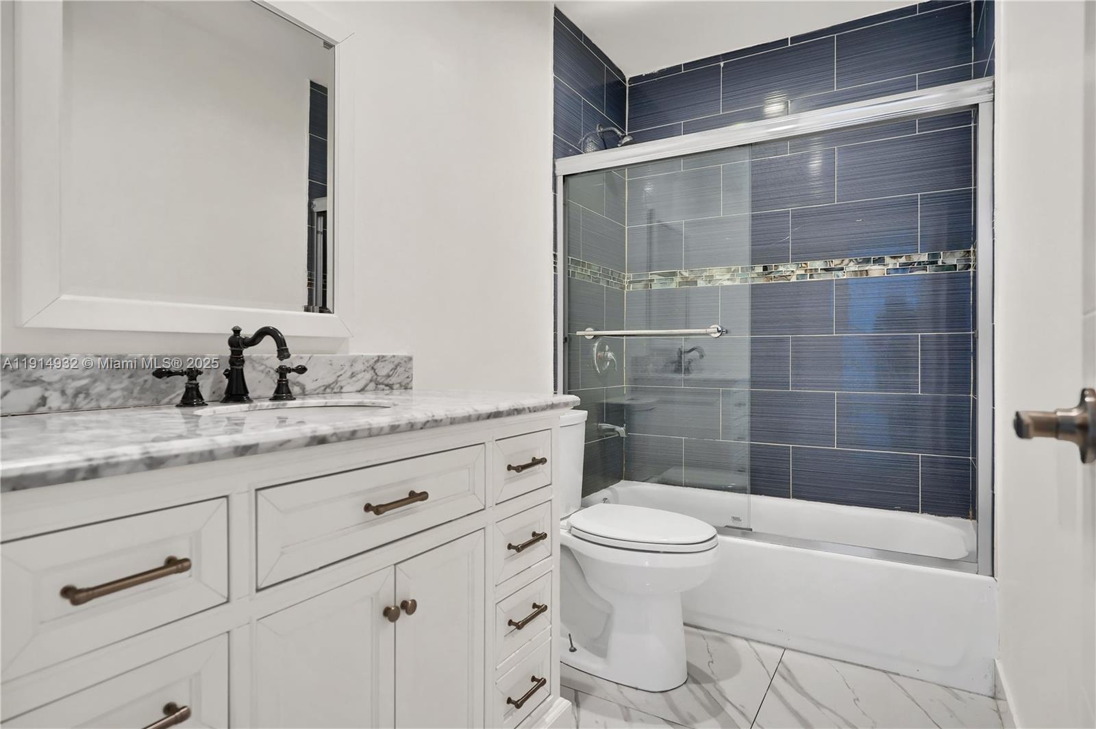 4721 West Park Road Hollywood, FL 33021 - Photo 23 of 34 a bathroom with a granite countertop sink a toilet a mirror and shower