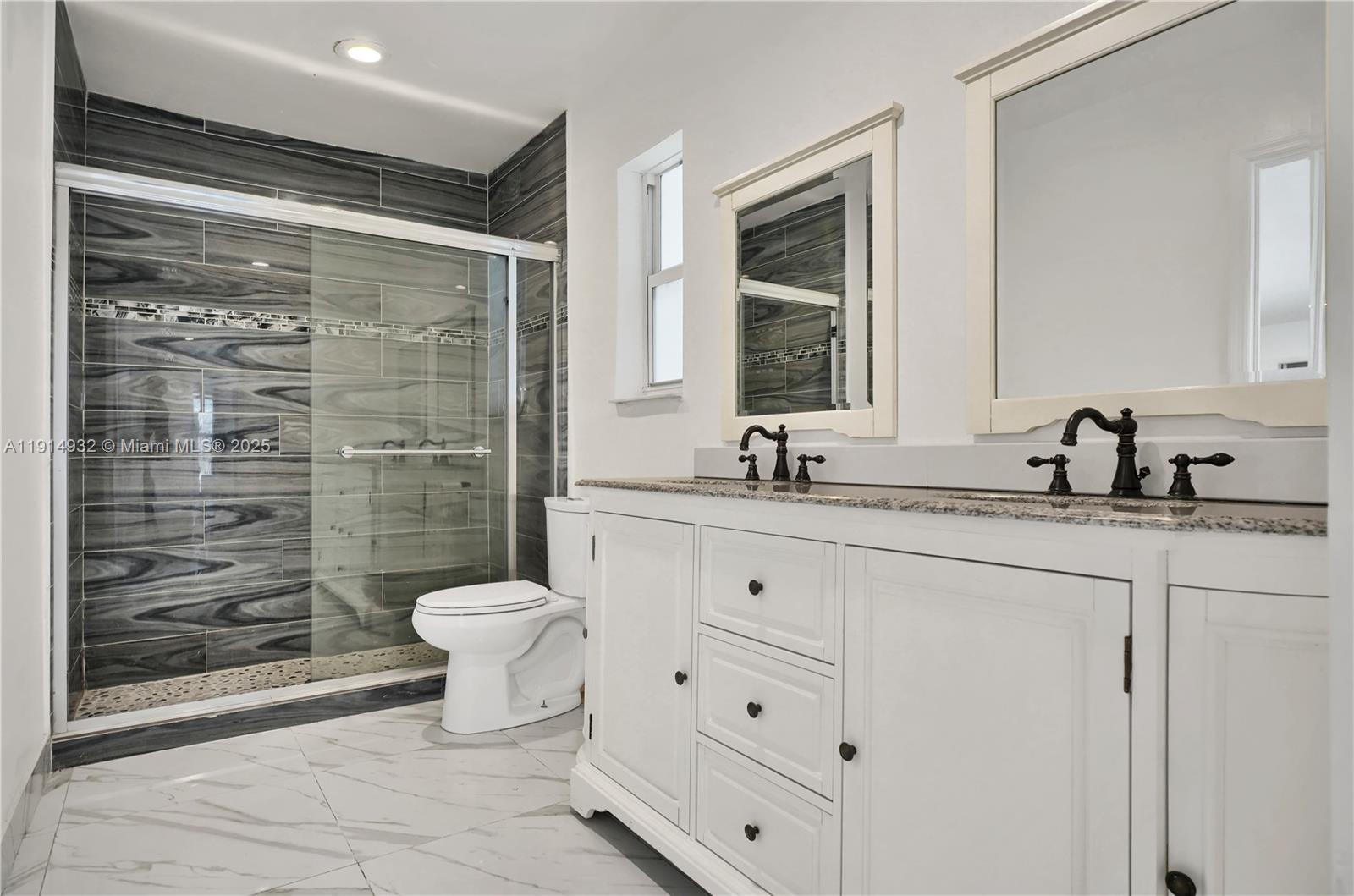 4721 West Park Road Hollywood, FL 33021 - Photo 24 of 34 a bathroom with a double vanity sink toilet and shower