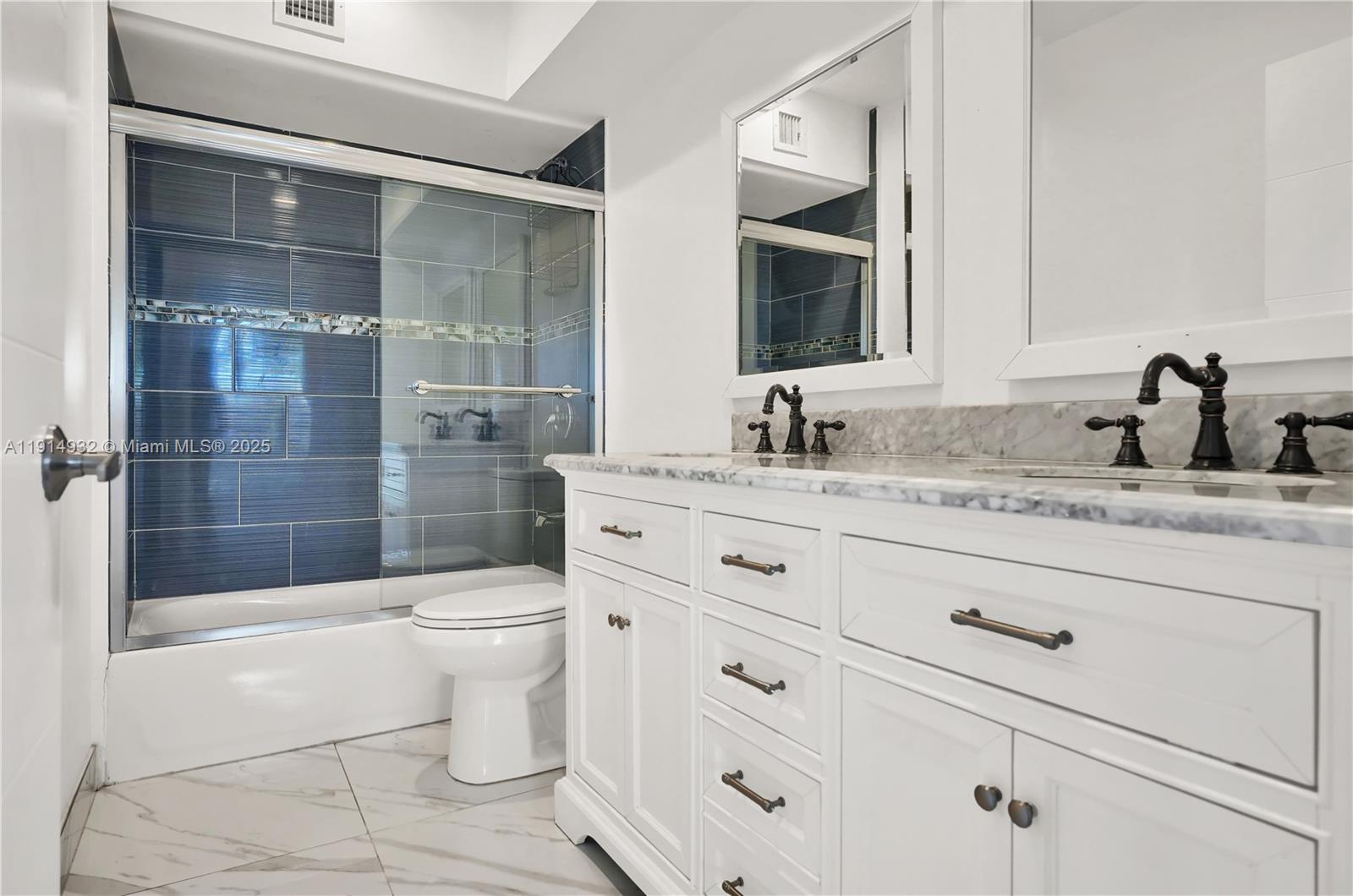 4721 West Park Road Hollywood, FL 33021 - Photo 25 of 34 a bathroom with a sink a toilet and shower
