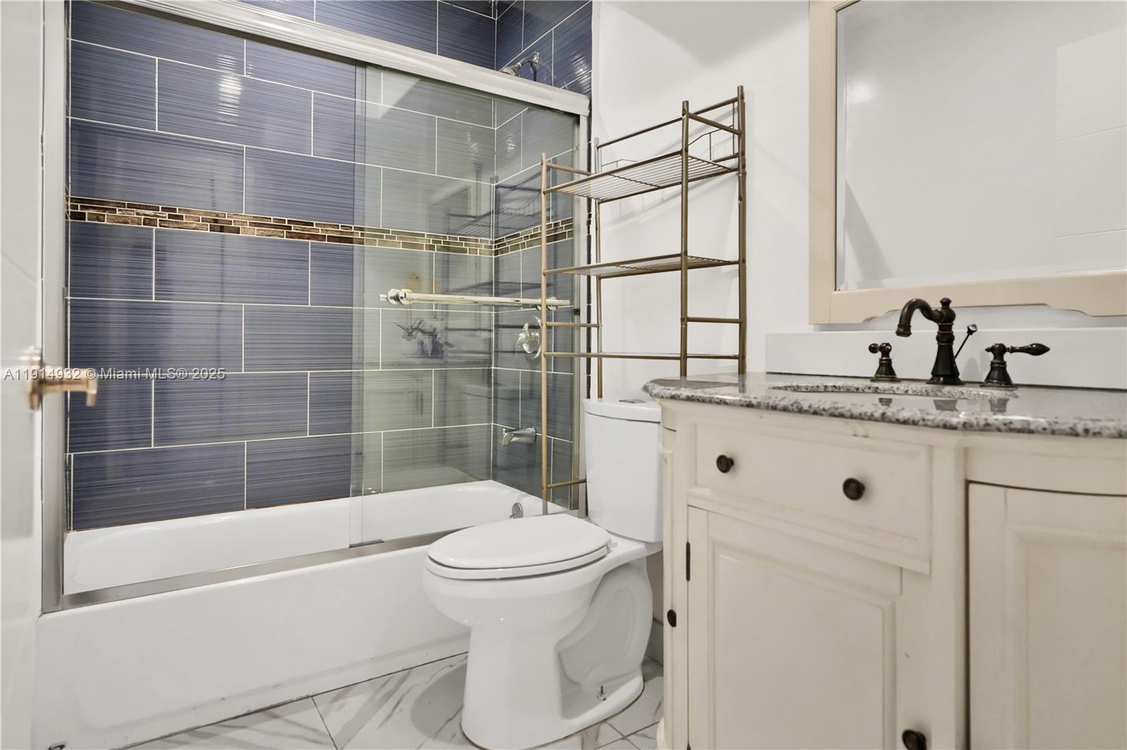 4721 West Park Road Hollywood, FL 33021 - Photo 26 of 34 a bathroom with a bathtub shower sink vanity and toilet