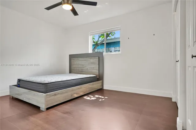 a living room with furniture and a ceiling fan