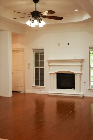 a view of an empty room with a fireplace and a window