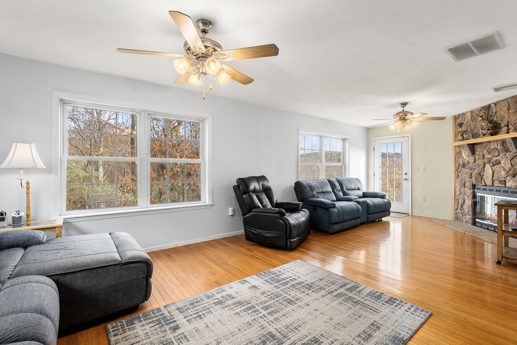 597 Old Warren Road Palmer, MA 01069 - Photo 11 of 37 a living room with furniture ceiling fan and a rug
