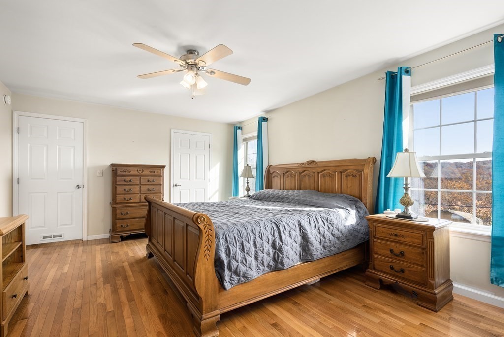 597 Old Warren Road Palmer, MA 01069 - Photo 17 of 37 a bedroom with a bed and wooden floor