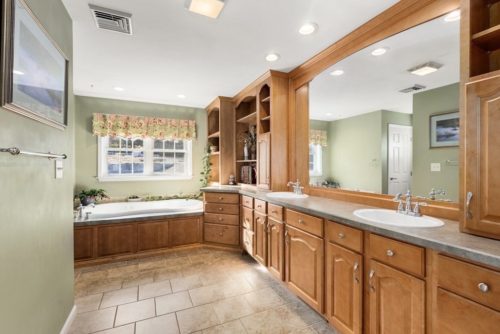 597 Old Warren Road Palmer, MA 01069 - Photo 18 of 37 a large bathroom with a large tub sink and double vanity