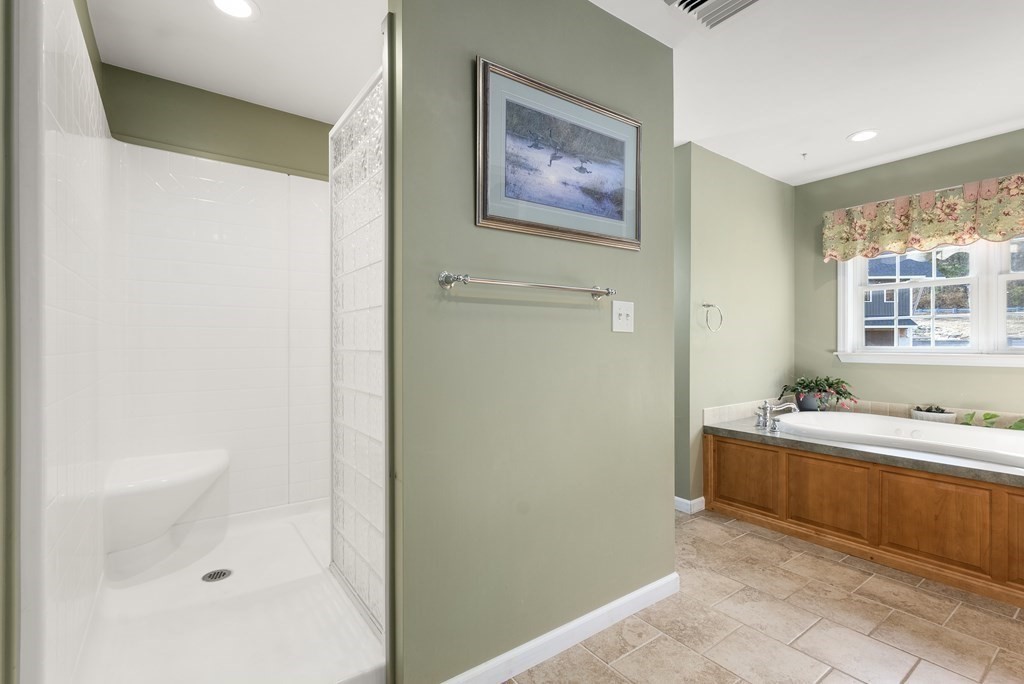 597 Old Warren Road Palmer, MA 01069 - Photo 20 of 37 a bathroom with a tub sink and mirror