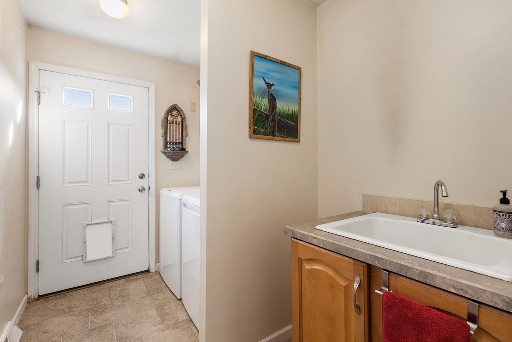 597 Old Warren Road Palmer, MA 01069 - Photo 26 of 37 a utility room with a sink and a mirror