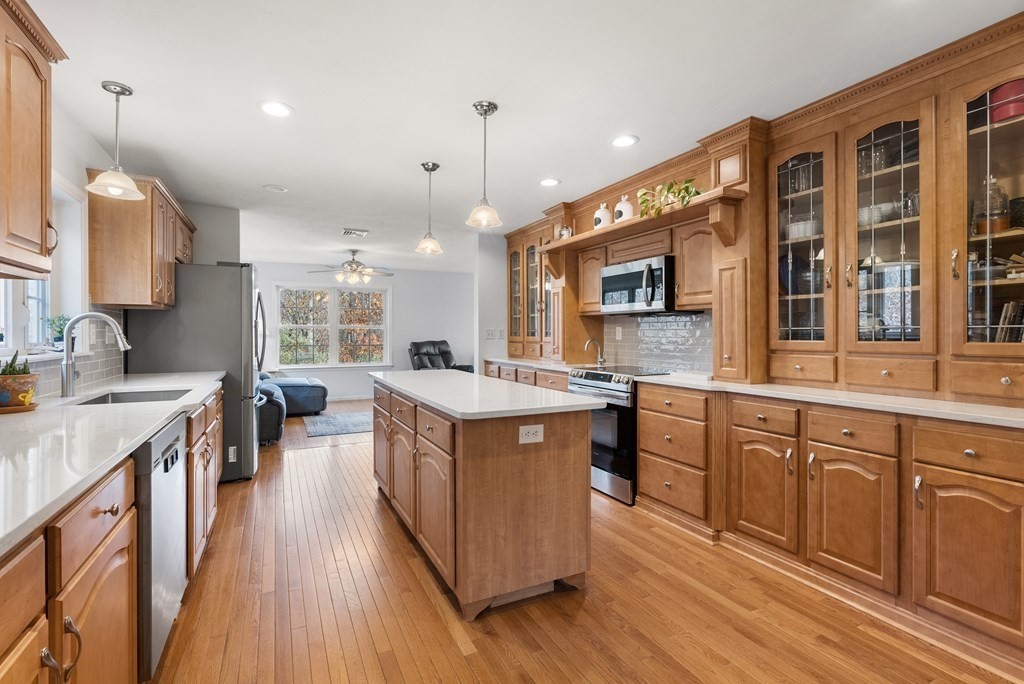597 Old Warren Road Palmer, MA 01069 - Photo 4 of 37 a kitchen with stainless steel appliances granite countertop wooden floors and stove