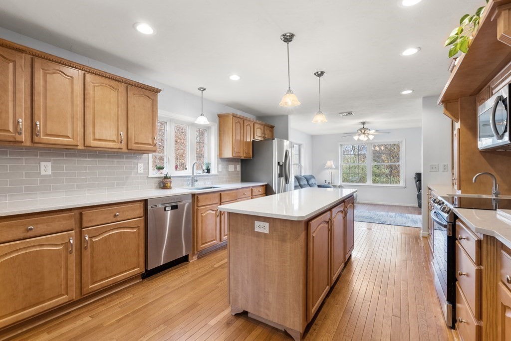 597 Old Warren Road Palmer, MA 01069 - Photo 6 of 37 a kitchen with a sink stove and wooden cabinets