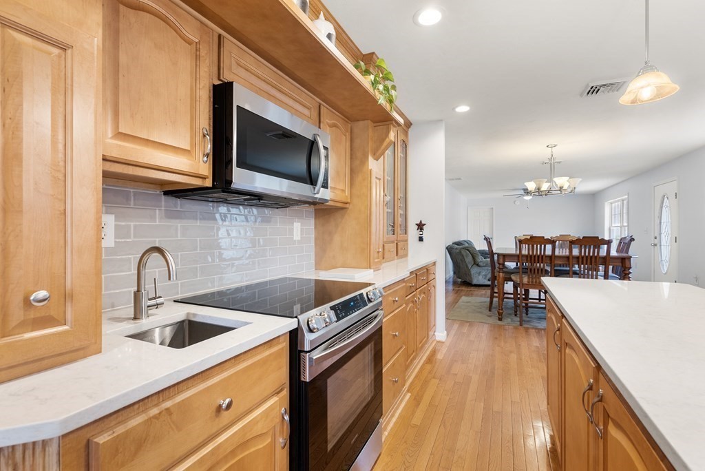 597 Old Warren Road Palmer, MA 01069 - Photo 8 of 37 a kitchen with kitchen island a sink appliances and cabinets