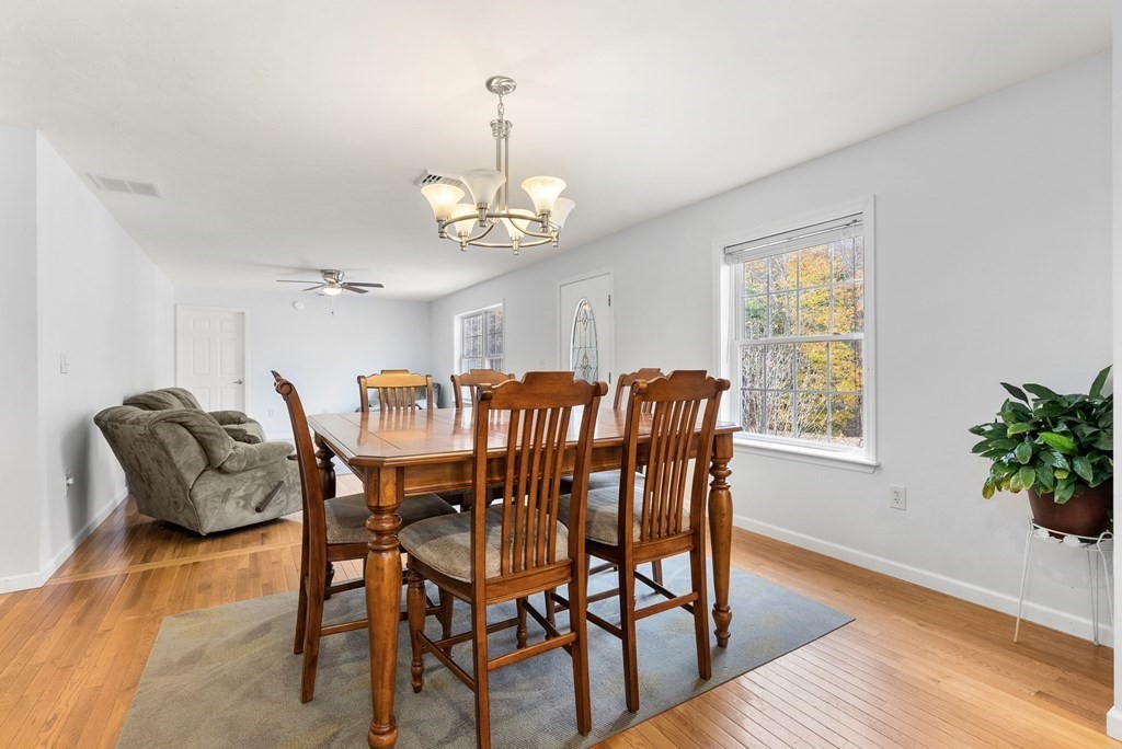 597 Old Warren Road Palmer, MA 01069 - Photo 10 of 37 a view of a dining room with furniture wooden floor and chandelier