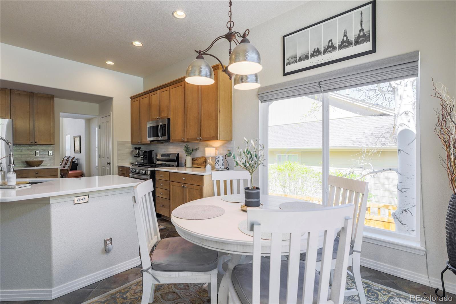3754 Broadview Place Castle Rock, CO 80109 - Photo 14 of 43 a kitchen with a table chairs stove and cabinets