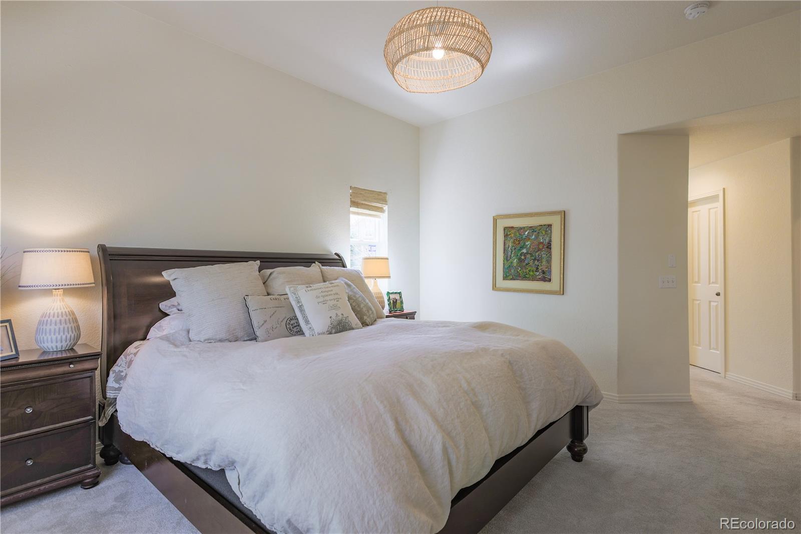 3754 Broadview Place Castle Rock, CO 80109 - Photo 22 of 43 a bedroom with a bed and a lamp