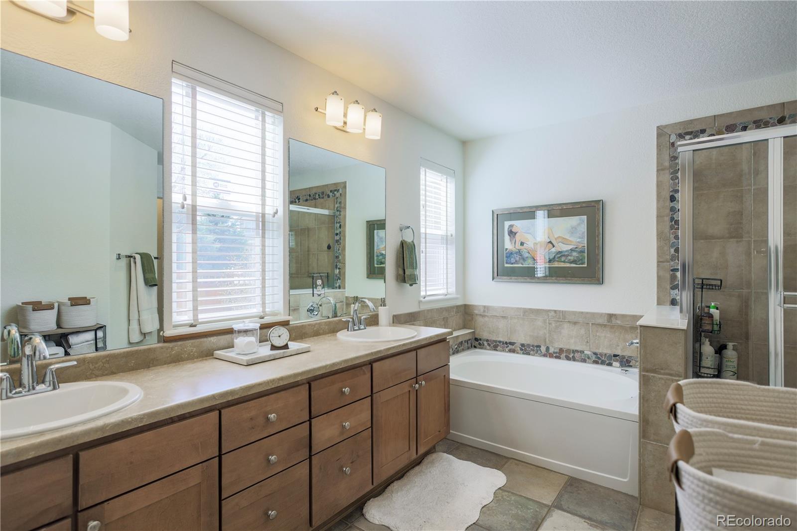 3754 Broadview Place Castle Rock, CO 80109 - Photo 23 of 43 a bathroom with a tub double sink window and mirror