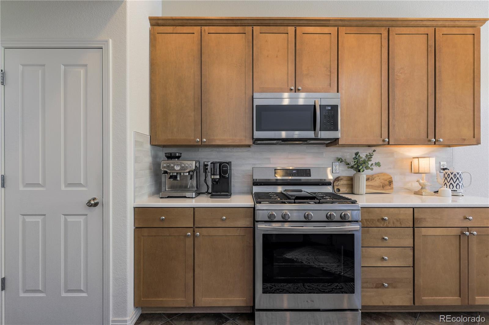 3754 Broadview Place Castle Rock, CO 80109 - Photo 10 of 43 a kitchen with granite countertop cabinets stainless steel appliances and sink