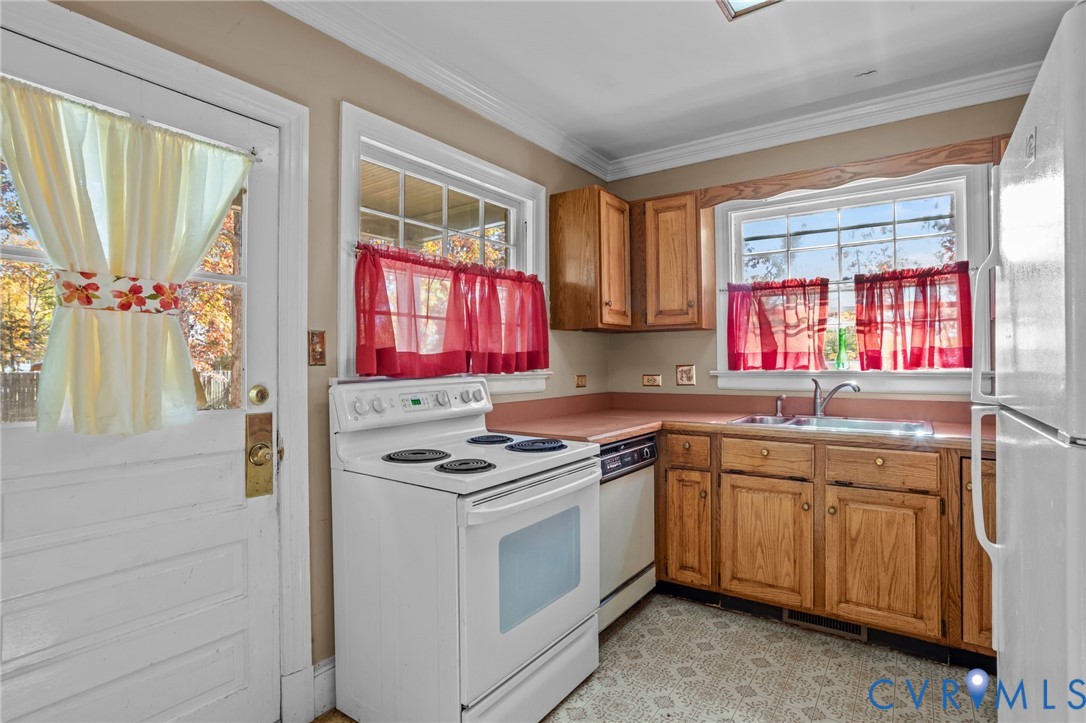 6800 Bethlehem Road Henrico, VA 23228 - Photo 2 of 25 Kitchen with white appliances, brown cabinetry, li