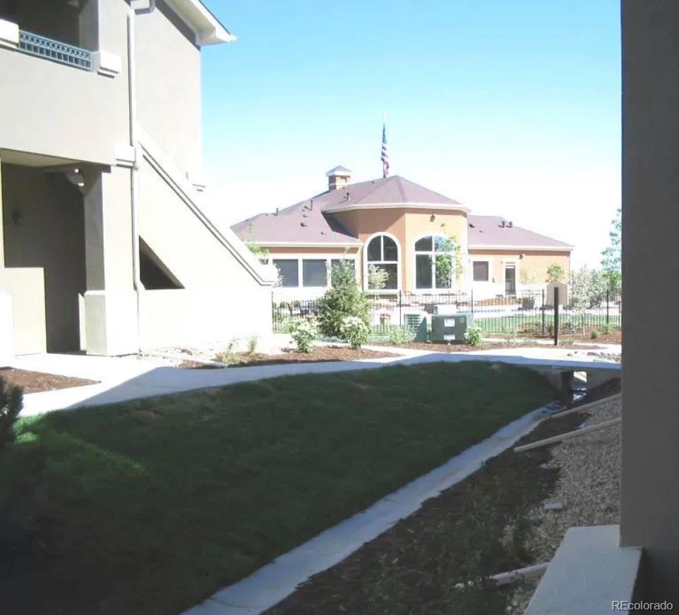 4730 Copeland Circle, Unit 101 Highlands Ranch, CO 80126 - Photo 12 of 14 a front view of a house with a yard